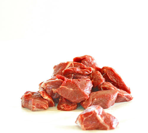 beef+stew Fresh raw beef chunks piled on a white background, ideal for stews and hearty meals.